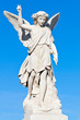 Marble statue of a young angel with a blue sky background