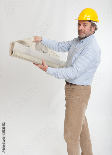 Photo: Male with helmet and blueprints Male with helmet and blueprints