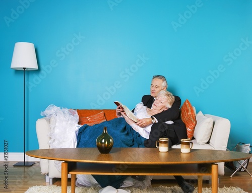 Photo: Senior Couple Reading On The Couch Together Senior Couple Reading On The Couch Together