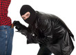 Photo: thief in black jacket and balaclava - pickpocket in action thief in black jacket and balaclava - pickpocket in action