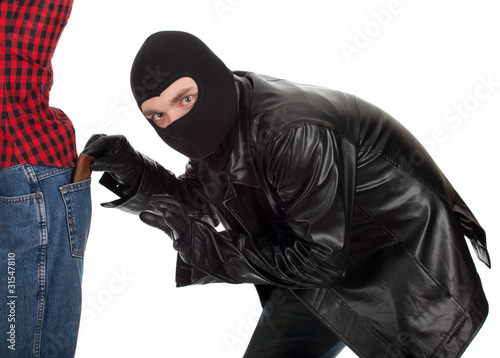 Photo: thief in black jacket and balaclava - pickpocket in action thief in black jacket and balaclava - pickpocket in action