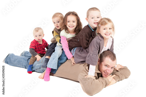 Photo: Children having fun playing with dad Children having fun playing with dad