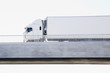 Semi-truck driving on overpass