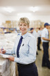 Worker writing on clipboard in shipping area