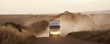 Semi-truck driving on dirt road