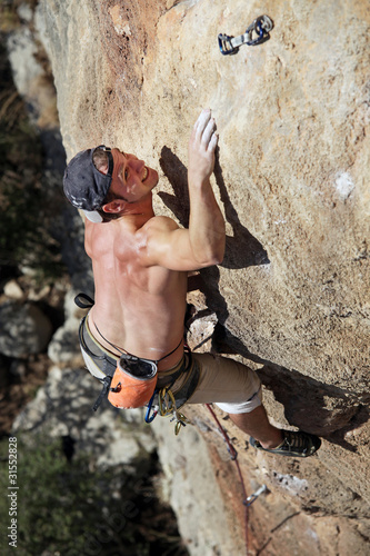 Photo: Rock climber reaching top of route Rock climber reaching top of route