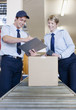 Foto: Workers standing together near box on conveyor belt Workers standing together near box on conveyor belt