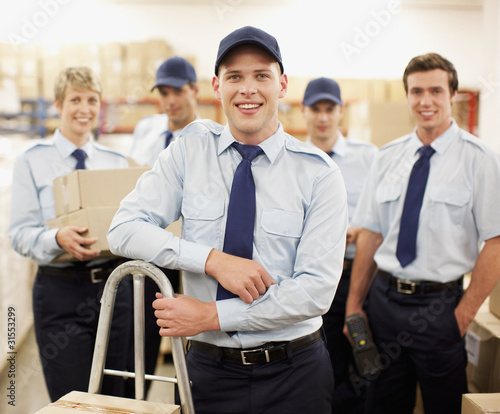 Photo: Workers standing together in shipping area Workers standing together in shipping area