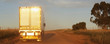 Semi-truck driving on dirt road