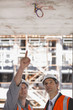 Construction workers looking at ceiling on construction site