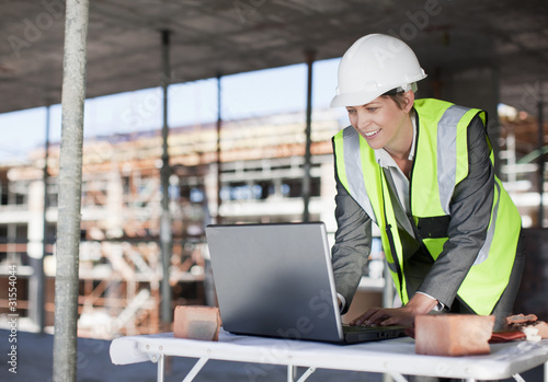 Photo: Construction worker using laptop on construction site Construction worker using laptop on construction site