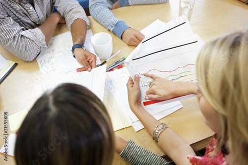 Photo: Business people working together in office Business people working together in office