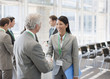 Business people shaking hands at seminar