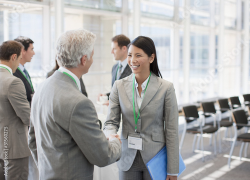 Photo: Business people shaking hands at seminar Business people shaking hands at seminar