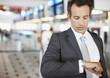 Businessman checking watch in airport
