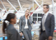 Businesswoman talking on cell phone in airport