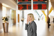 Businesswoman talking on cell phone in airport