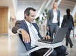 Businessman using laptop in airport