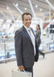 Businessman standing with briefcase in airport