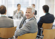 Business people attending seminar in office
