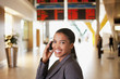 Businesswoman talking on cell phone in airport