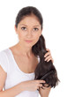 Photo: Young brunette beautiful woman combing long hairs Young brunette beautiful woman combing long hairs