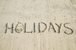 Holidays Written In Sand.