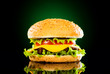 Tasty hamburger and french fries on a dark Tasty hamburger and french fries on a dark