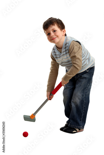 Photo: Happy boy preparing to hit a golf ball Happy boy preparing to hit a golf ball