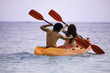 young asian couple in their kayak in hawaii young asian couple in their kayak in hawaii
