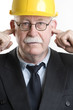 Construction worker with fingers in his ears
