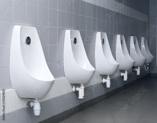 Photo: modern restroom interior with urinal row modern restroom interior with urinal row