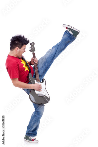 Photo: kicking guitarist playing kicking guitarist playing