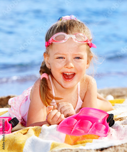 Photo: Child playing on beach. Child playing on beach.