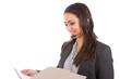 Businesswoman reading a file while on the phone
