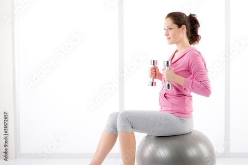 Photo: Fitness woman exercise dumbbell ball gym Fitness woman exercise dumbbell ball gym
