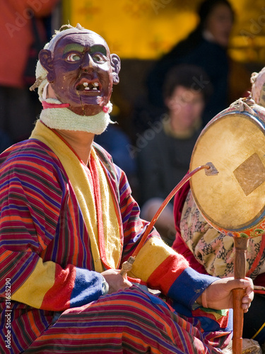 Photo: Bumthang, Bhutan - October 2010: A masked man making music durin Bumthang, Bhutan - October 2010: A masked man making music durin