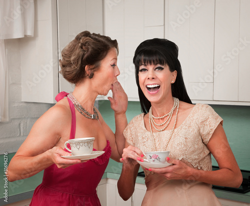 Photo: Woman Whispers Joke Woman Whispers Joke