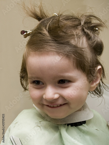 Foto: Small girl at hairdresser's Small girl at hairdresser's