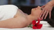 Beautiful young woman receiving face massage in Spa
