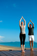 Yoga Couple By Ocean