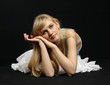 Young beautiful woman is lying on floor.