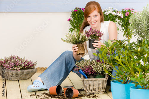 Photo: Summer garden terrace redhead woman hold flower Summer garden terrace redhead woman hold flower