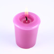 Lavender candle burning on a white background Lavender candle burning on a white background