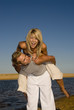 Young couple playing at the beach