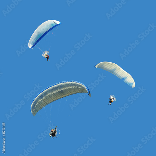 Photo: White blue paramotor on blue sky White blue paramotor on blue sky