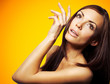 Portrait of a beautiful young woman on a yellow background