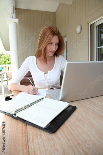 Photo: Woman working at home on laptop computer Woman working at home on laptop computer