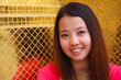 Thai women smiling with golden tile in background