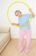 senior lady doing gymnastic with hula-hoop